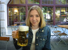 A minature woman with a pint